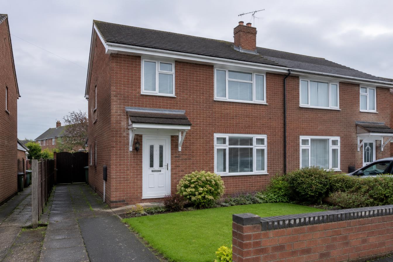 Illustrative red-brick semi-detached starter home in the English Midlands; not a real clients' property